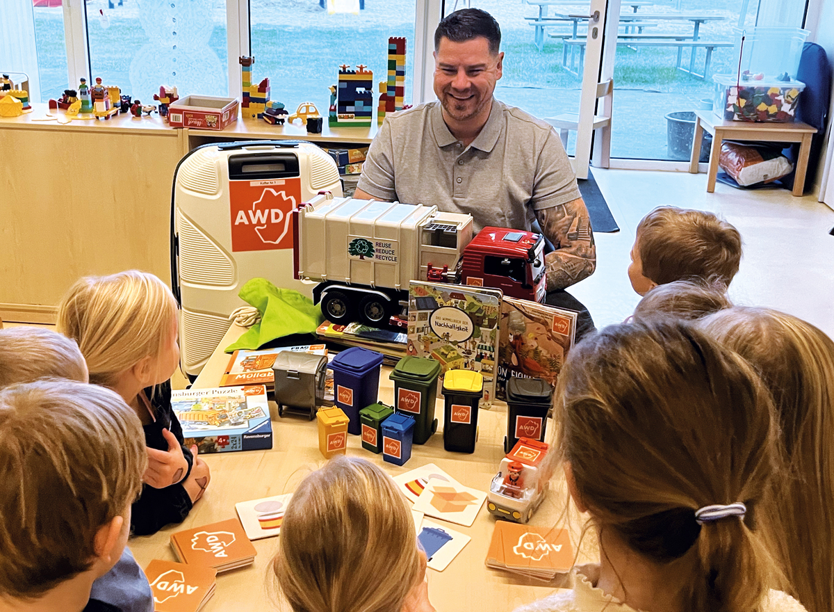 Umweltbildner Ole erklärt Kindergartenkindern den AWD-Umweltkoffer.